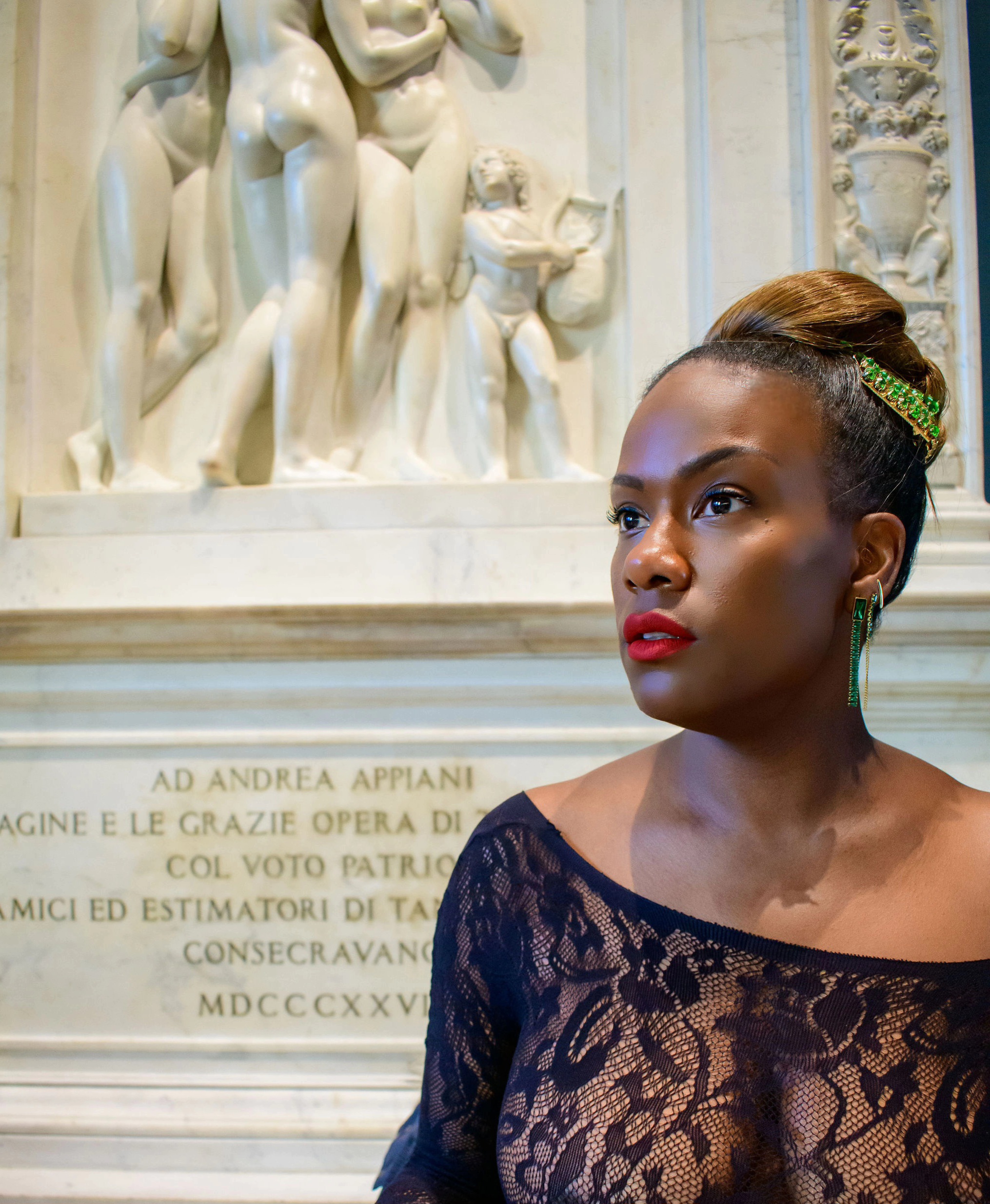 Naima Singletary standing before monumental marble sculpture